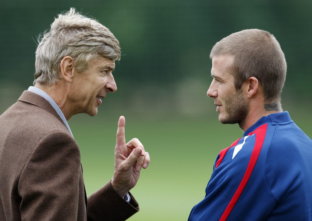 England's David Beckham (R) talks to Arsenal manager Arsene Wenger during an England training session.