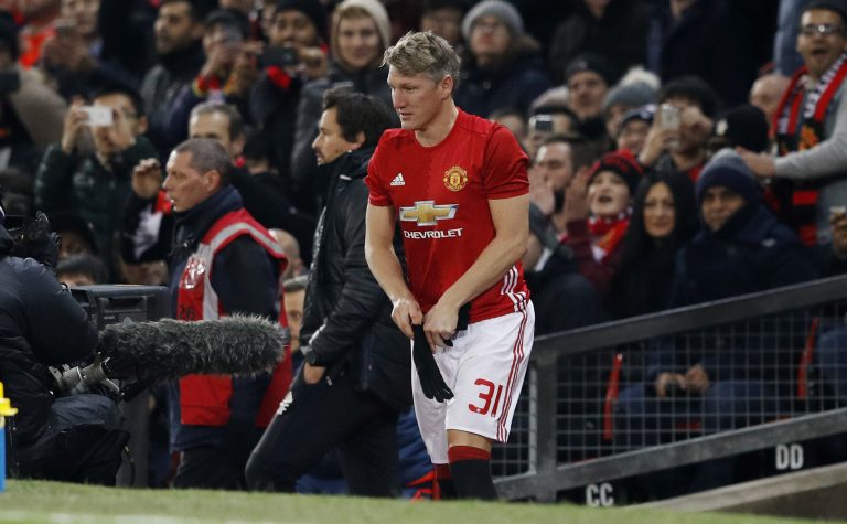 Bastian Schweinsteiger prepares to come on as a substitute.