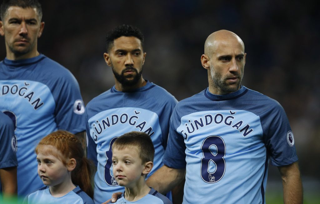 Pablo Zabaleta and Gael Clichy wear shirts in support of injured team mate Ilkay Gundogan.