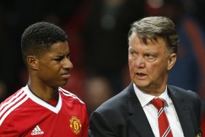 Marcus Rashford walks off at half time with Louis van Gaal.