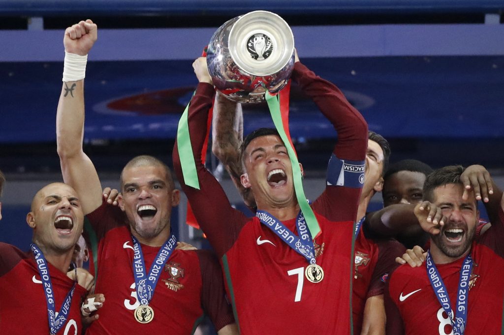 Portugal's Cristiano Ronaldo celebrates with Pepe, Ricardo Quaresma and Joao Moutinho and the trophy after winning Euro 2016.