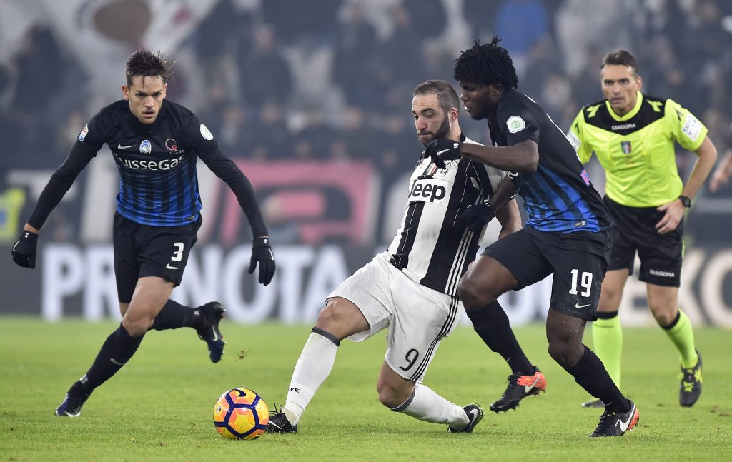 Gonzalo Higuain in action with Atalanta's Rafael Toloi and Franck Kessie.