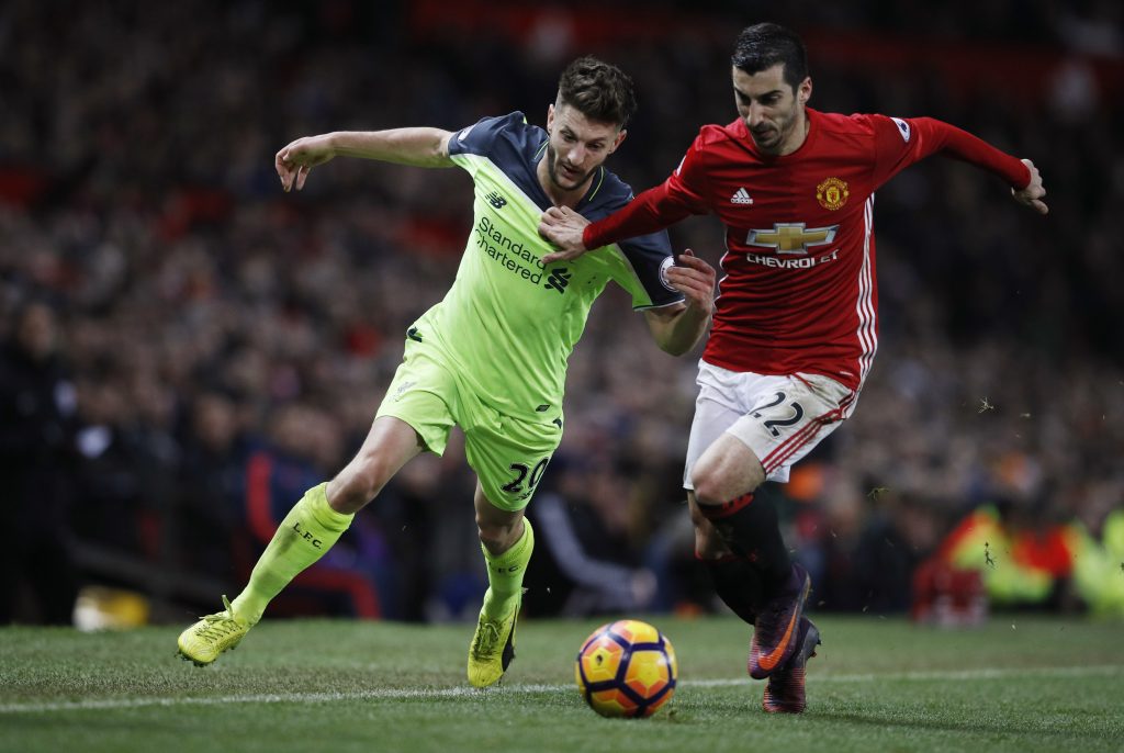 Adam Lallana in action with Henrikh Mkhitaryan.