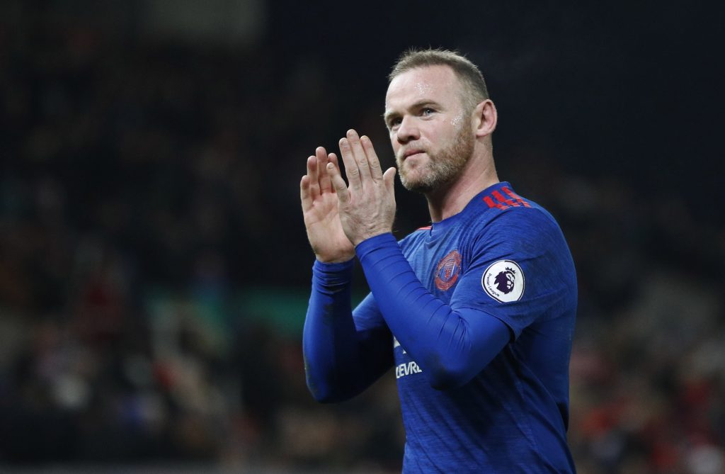Wayne Rooney applauds fans after the game.
