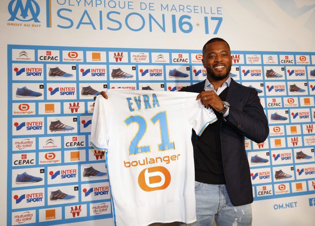 Olympique Marseille's latest recruit Patrice Evra displays his new jersey.c