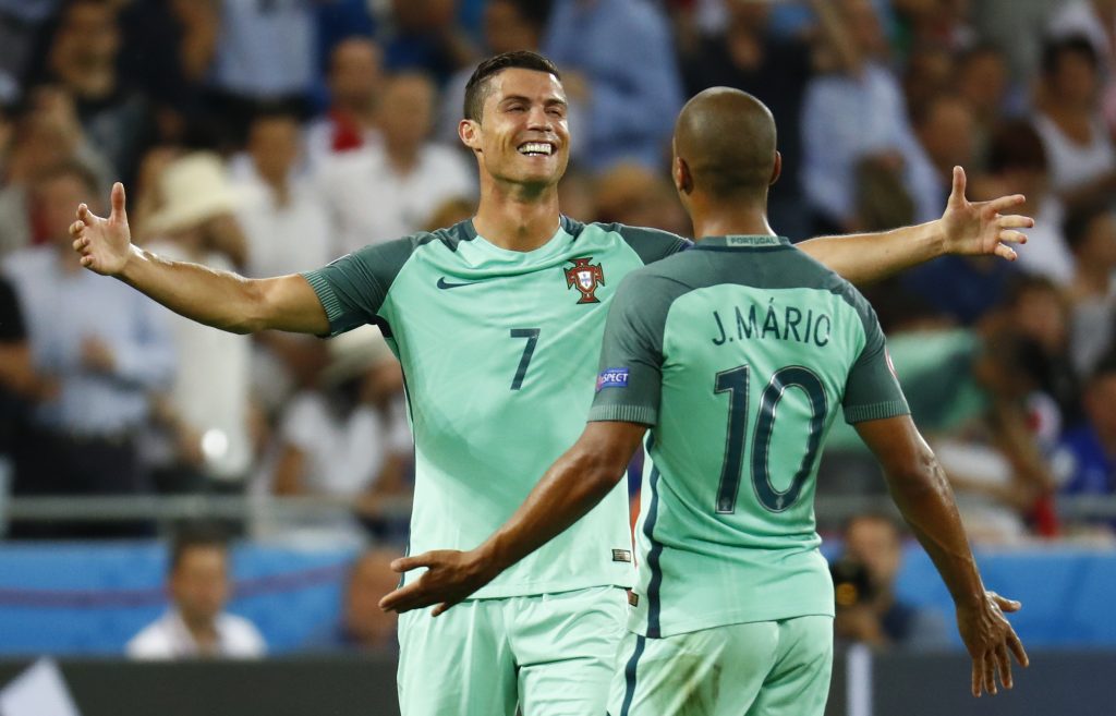 Portugal's Cristiano Ronaldo celebrates with Joao Mario at the end of the match.
