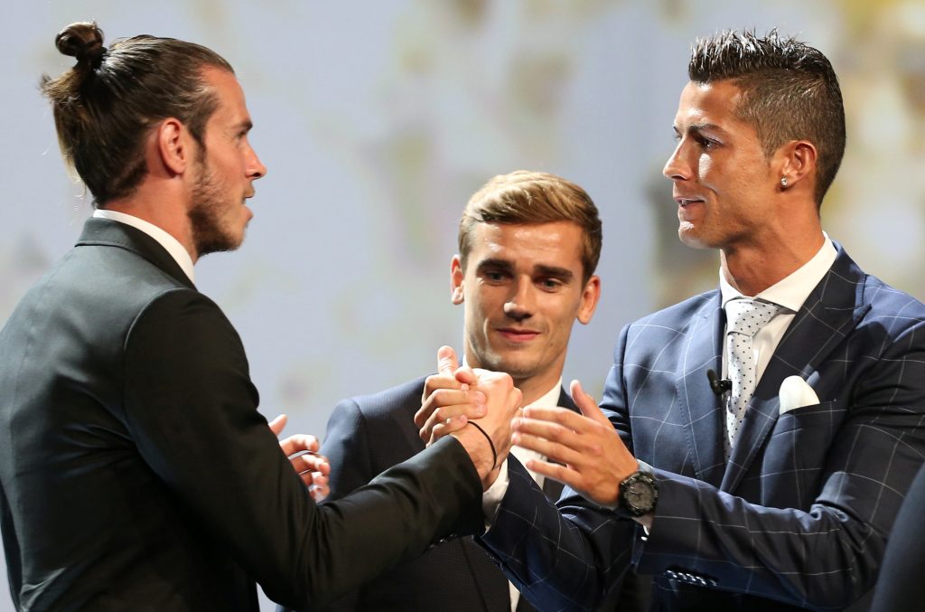Real Madrid's Cristiano Ronaldo (R) reacts with Gareth Bale (L) and Antoine Griezmann (C) after he received the Best Player UEFA 2015/16 Award.