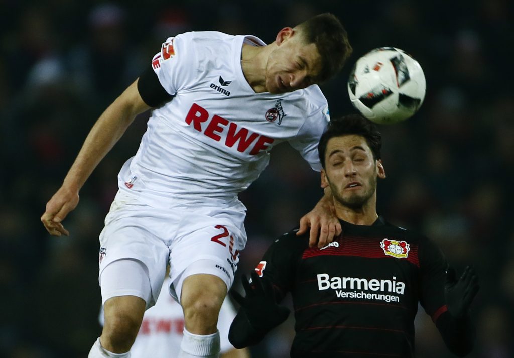 FC Cologne's Salih Oezcan (L) in action with Bayer Leverkusen's Hakan Calhanoglu.