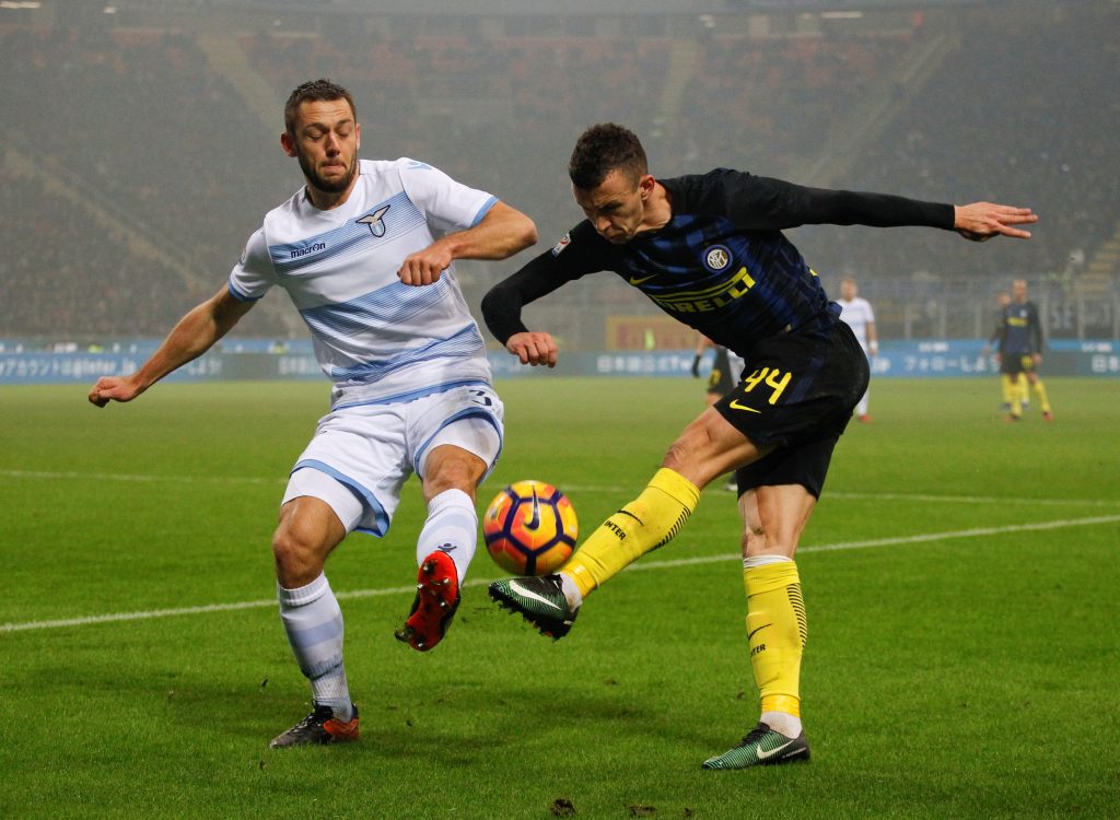 Inter Milan's Ivan Perisic (R) and Lazio's Stefan De Vrij fight for the ball.