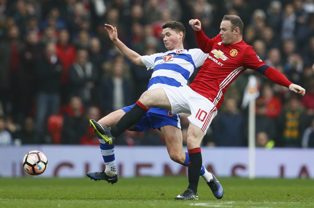 Wayne Rooney in action with Reading's George Evans.