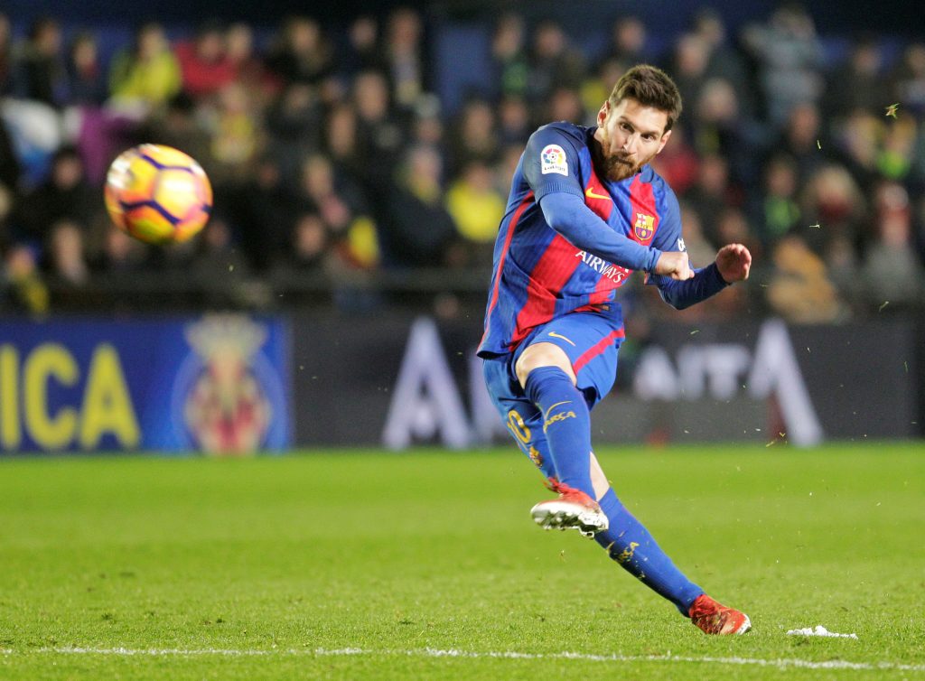 Lionel Messi shoots to score.