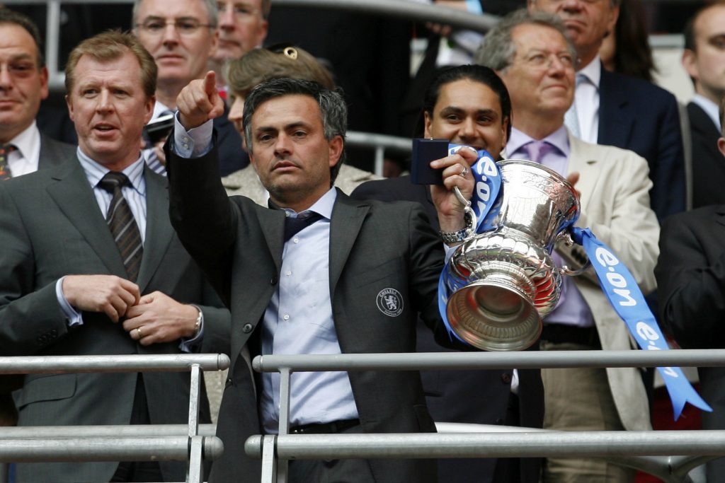 Jose Mourinho (2nd L) celebrates with the FA Cup trophy.