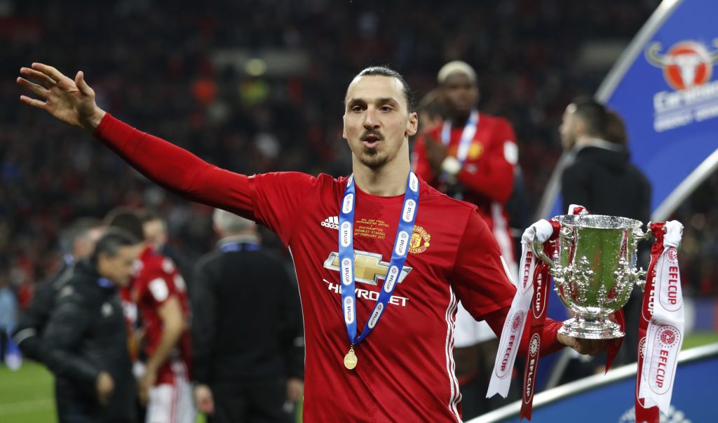 Manchester United's Zlatan Ibrahimovic celebrates with the trophy.