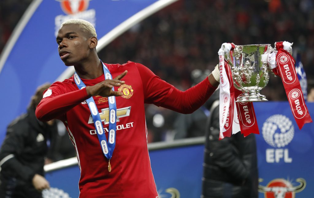 Manchester United's Paul Pogba celebrates with the trophy.