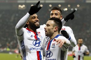 Alexandre Lacazette and Mathieu Valbuena (R) celebrate after scoring for Olympique Lyon.