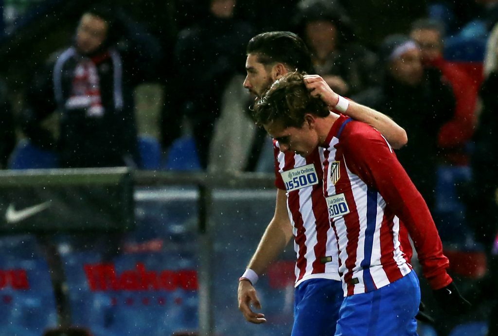 Atletico Madrid's Antoine Griezmann (R) is congratulated by teammate Yannick Ferreira-Carrasco.