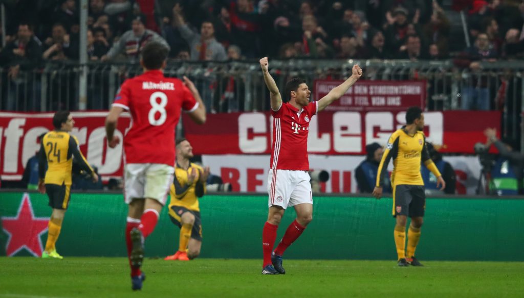 Bayern Munich's Xabi Alonso celebrates after Robert Lewandowski scores their second goal.