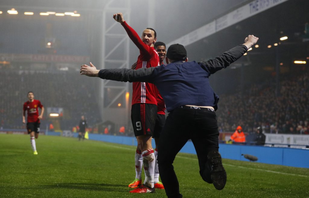 Manchester United's Zlatan Ibrahimovic celebrates scoring their second goal with team mates and fans.