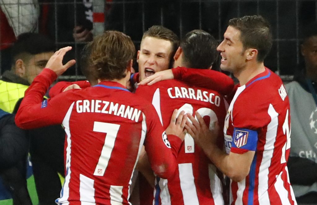 Kevin Gameiro celebrates scoring from the penalty spot with Yannick Carrasco and Antoine Griezmann.