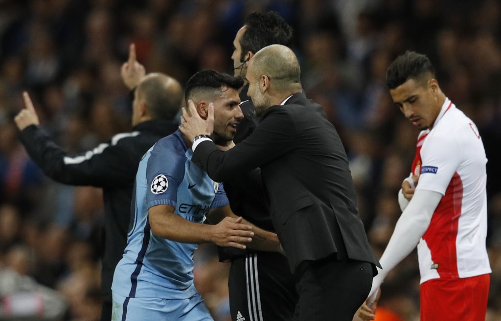 Sergio Aguero with Manchester City manager Pep Guardiola after being substituted.