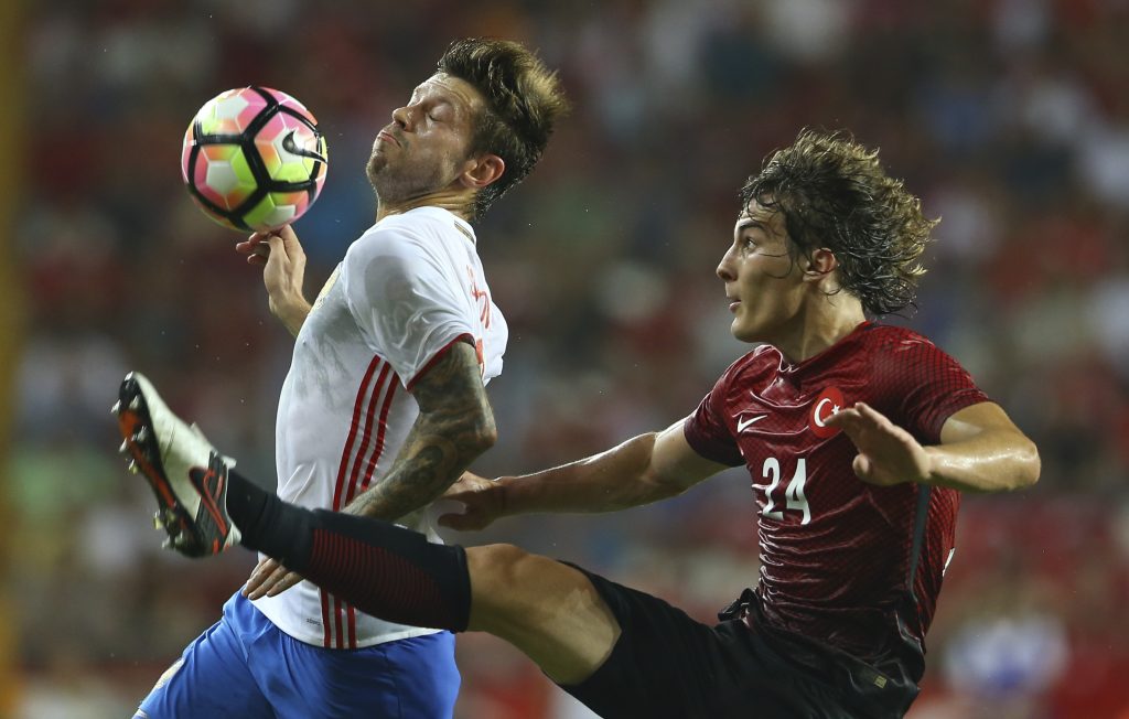 Turkey's Caglar Soyuncu (R) and Russia's Fedor Smolov in action.