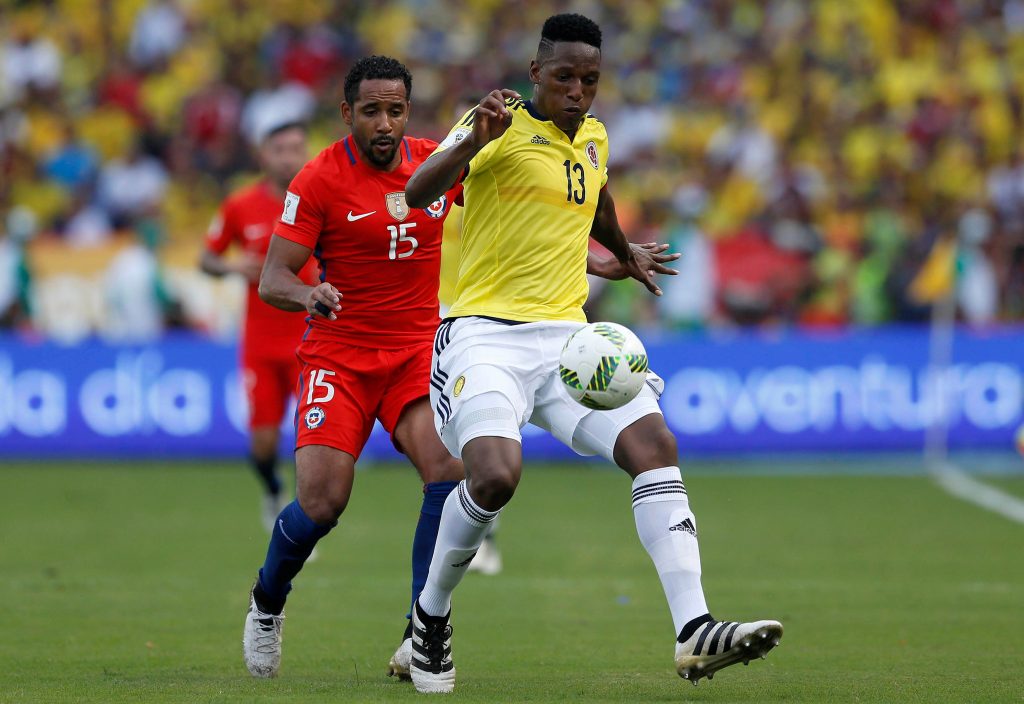 Colombia's Yerry Mina (R) and Chile's Jean Beausejour compete for the ball.