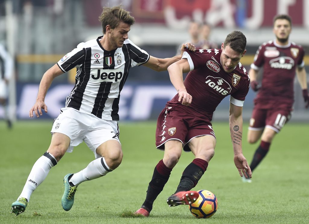 Juventus' Daniele Rugani in action with Torino's Andrea Belotti.