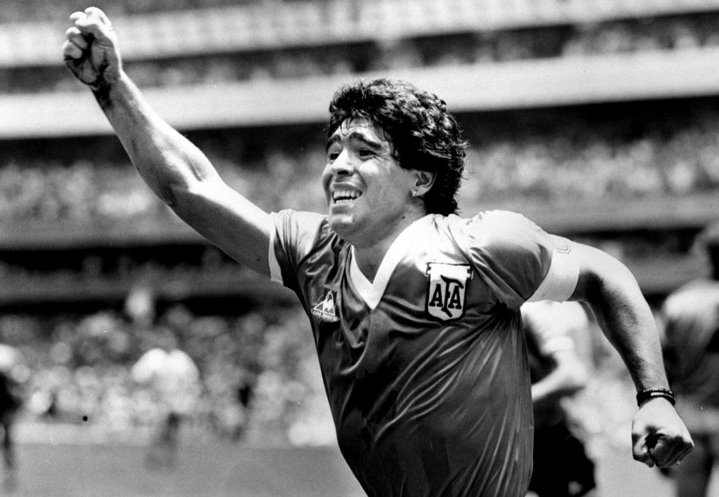 Argentinian star Diego Maradona raises his arm in the air after scoring his game winning goal against England.