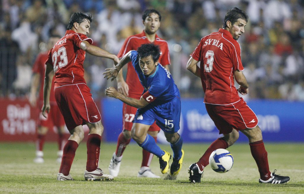 India's captain Bhaichung Bhutia (C) fights for the ball.