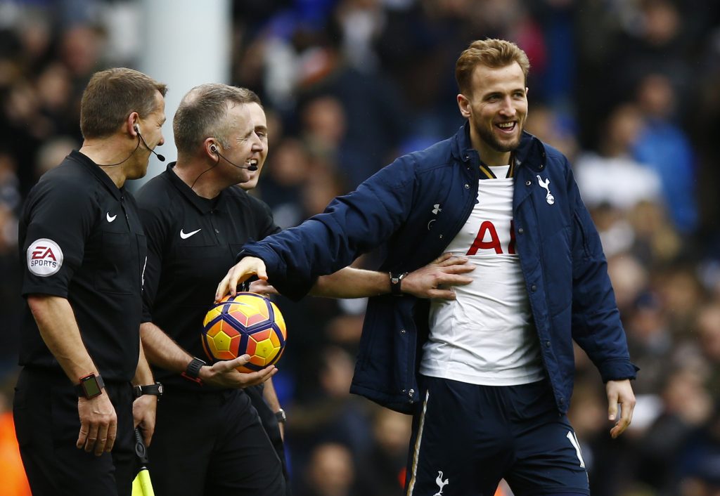Harry Kane takes the match ball from referee Jonathan Moss at the end of the match after completing a hat trick.