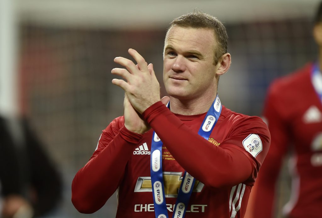 Manchester United's Wayne Rooney applauds fans as he celebrates winning the EFL Cup.