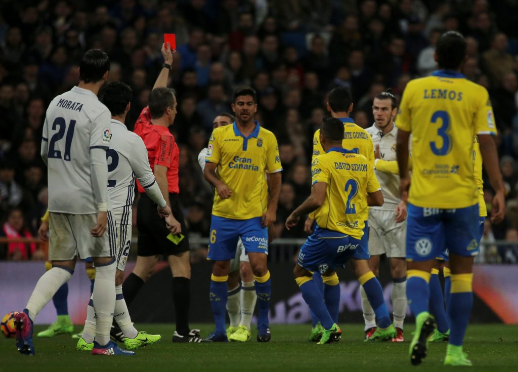 Real Madrid's Gareth Bale (2nd R) is sent off by the referee.