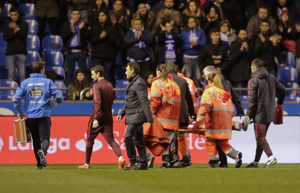 Paramedics carry Atletico Madrid's Fernando Torres on a stretcher to a waiting ambulance after he suffered a head injury during the match.