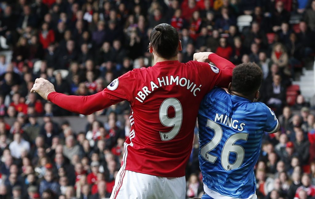 Bournemouth's Tyrone Mings is challenged by Manchester United's Zlatan Ibrahimovic.