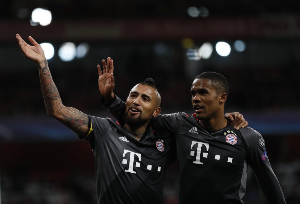 Bayern Munich's Arturo Vidal celebrates scoring their fifth goal with Douglas Costa.