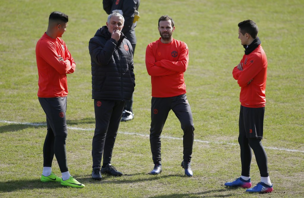 Manchester United coach Jose Mourinho with Juan Mata, Marcos Rojo and Ander Herrera during training.