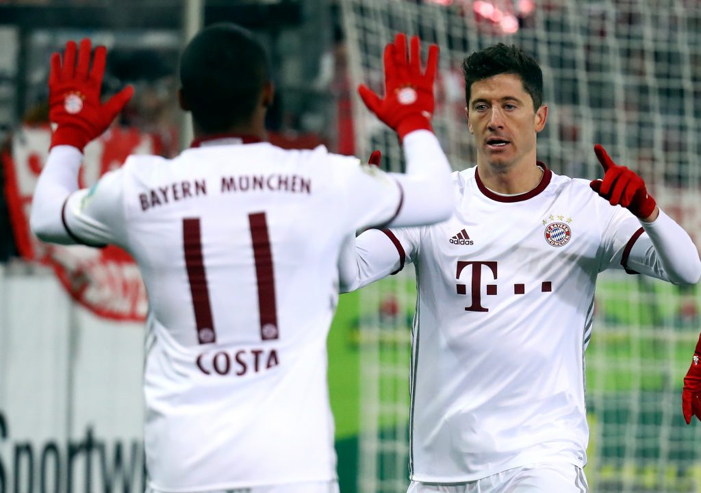 Bayern Munich's Robert Lewandowski and Douglas Costa celebrate a goal against Freiburg.