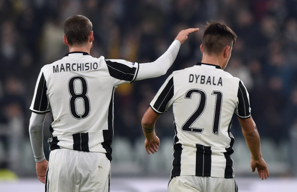 Juventus' Paulo Dybala is congratulated by his team mate Claudio Marchisio.