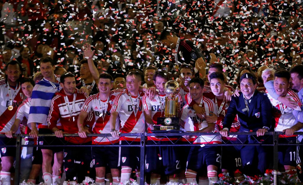 River Plate's players celebrate with the trophy after winning the match.