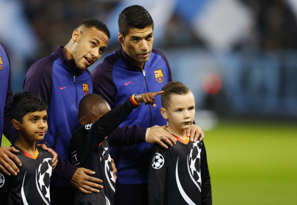 Barcelona's Neymar and Luis Suarez with mascots before the match.