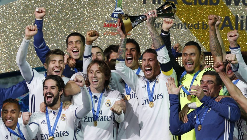 Sergio Ramos and team mates celebrate winning the FIFA Club World Cup Final with the trophy.