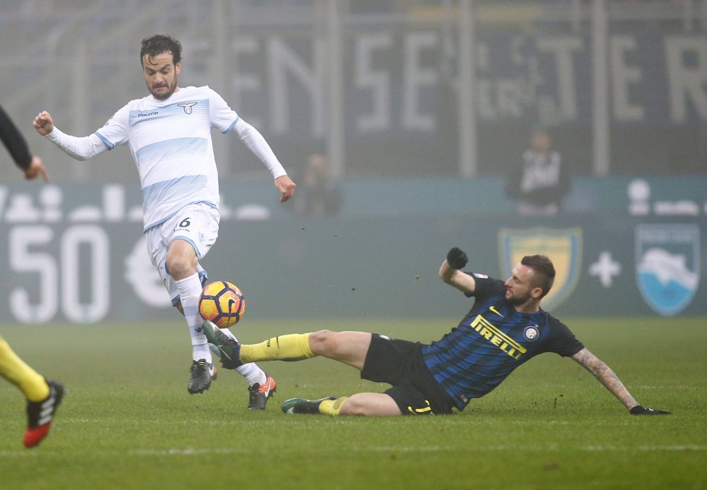 Inter Milan's Marcelo Brozovic (R) and Lazio's Marco Parolo fight for the ball.