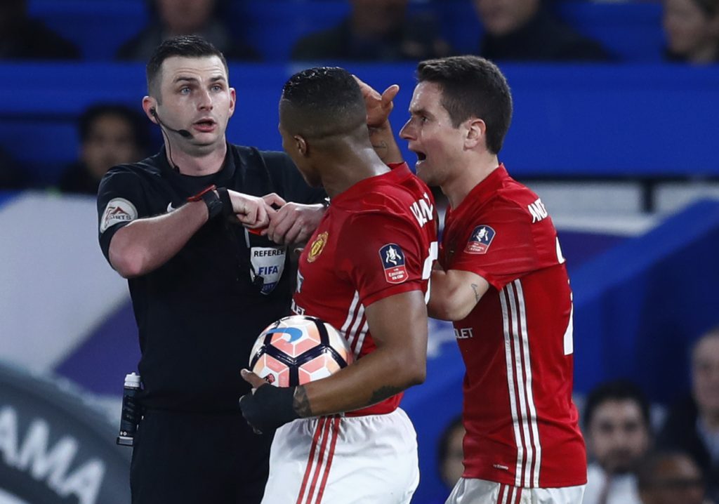 Manchester United's Ander Herrera is shown a red card by referee Michael Oliver.