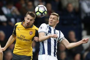 Arsenal's Aaron Ramsey in action with West Bromwich Albion's Darren Fletcher.