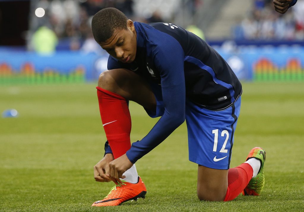 France's Kylian Mbappe warms up before the match.