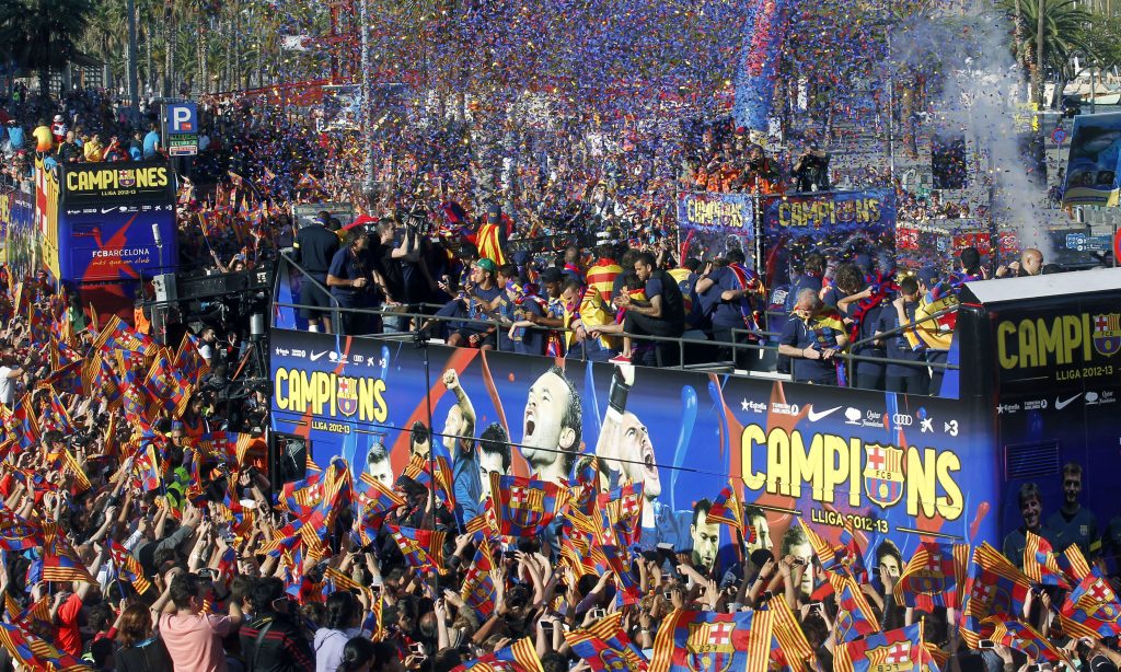 Barcelona's players celebrate on a bus with their supporters during their victory parade.