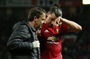 Manchester United's Zlatan Ibrahimovic receives medical attention after sustaining an injury.