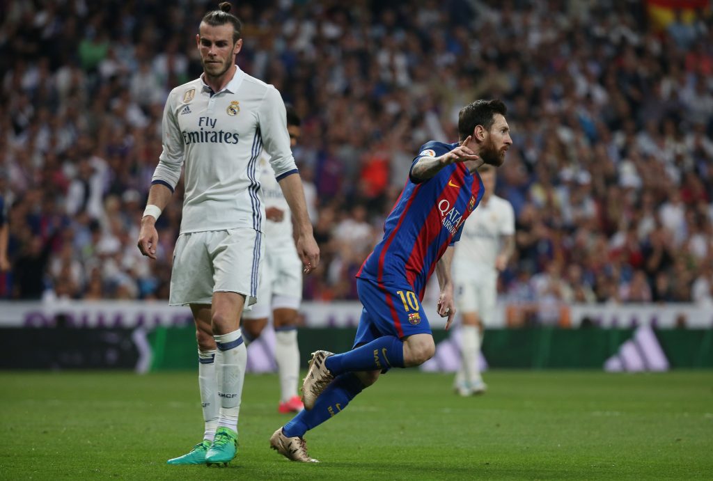 Barcelona's Lionel Messi celebrates scoring their first goal as Real Madrid's Gareth Bale looks dejected.