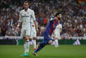 Barcelona's Lionel Messi celebrates scoring their first goal as Real Madrid's Gareth Bale looks dejected.
