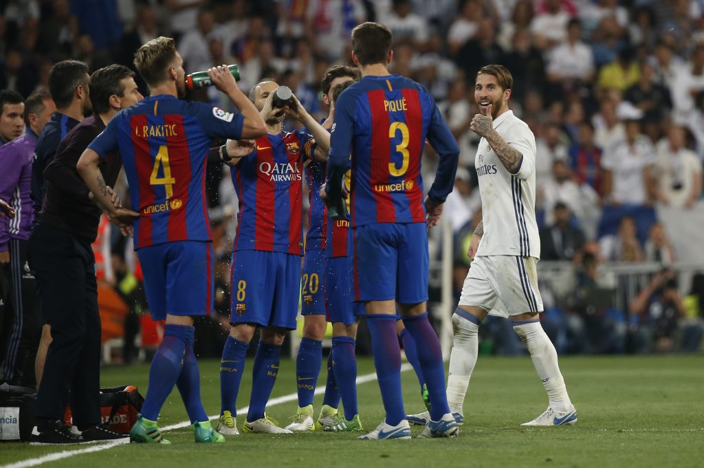 Real Madrid's Sergio Ramos gestures to Barcelona's Gerard Pique after being sent off.